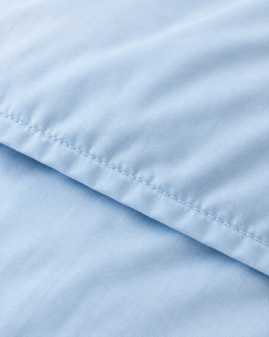 Close-up of stitched hem of the duvet cover in Baby Blue Silky Cotton