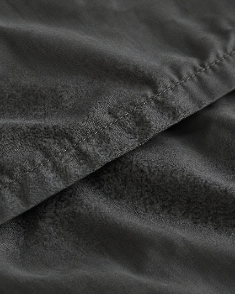 Close-up of stitched hem of the duvet cover in Charcoal Grey Silky Cotton