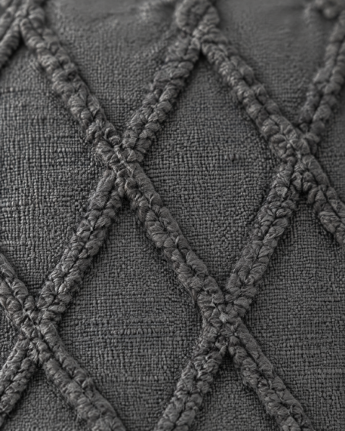 Close-up of raised tufted trellis lattice on charcoal