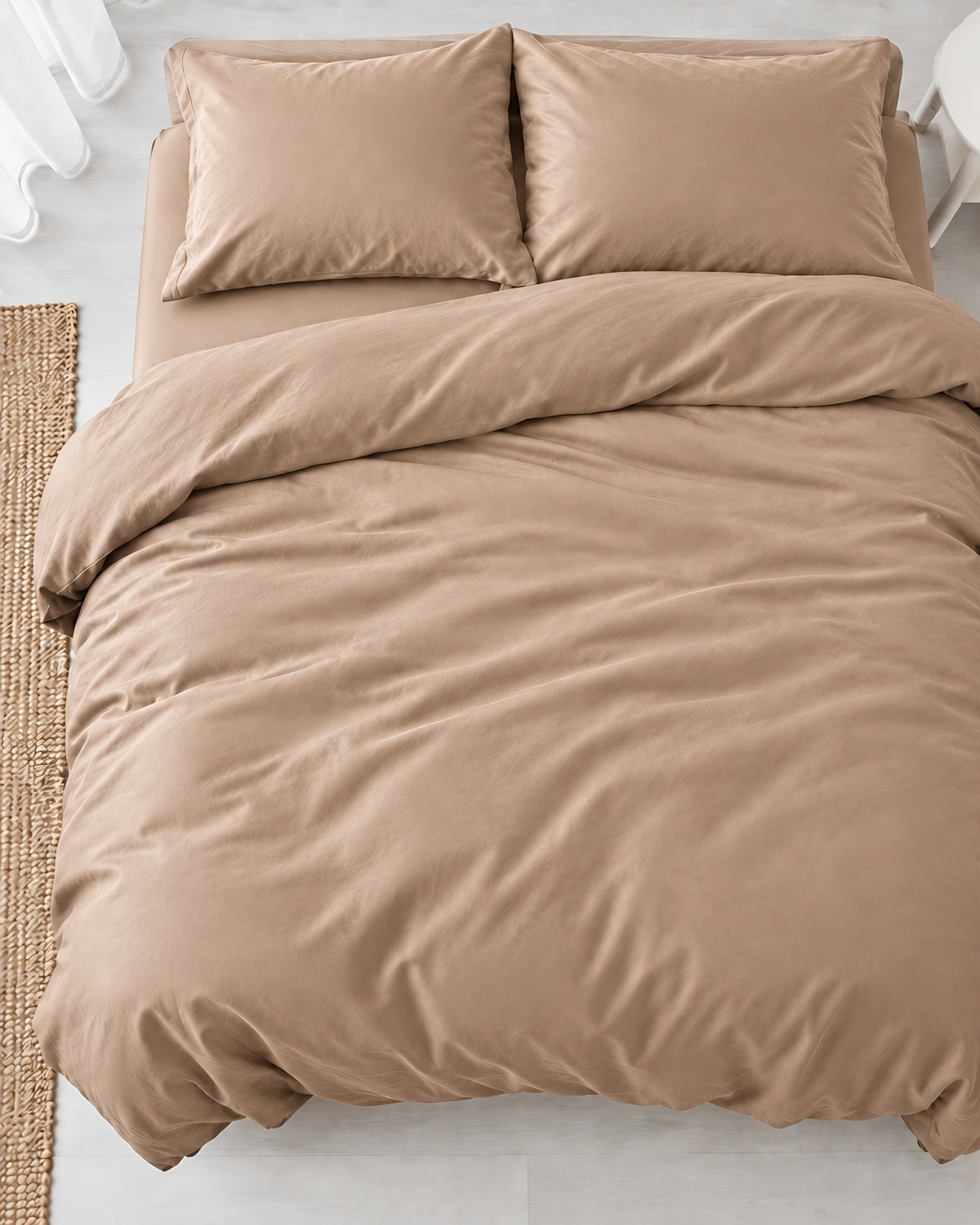 Overhead view of a Light Beige silky cotton duvet cover, beige cotton sateen, with two matching pillows on a made bed