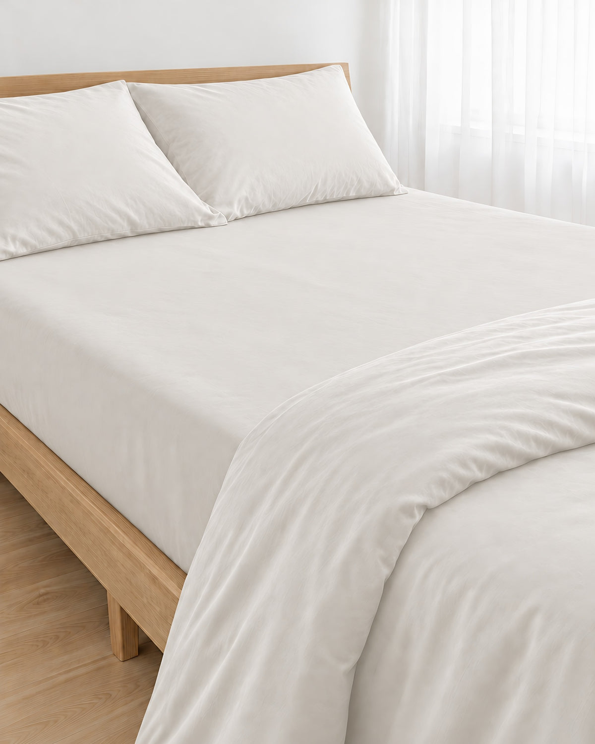 Milky White silky cotton fitted sheet, white 300 TC sateen, pulled taut over a mattress on an oak bed