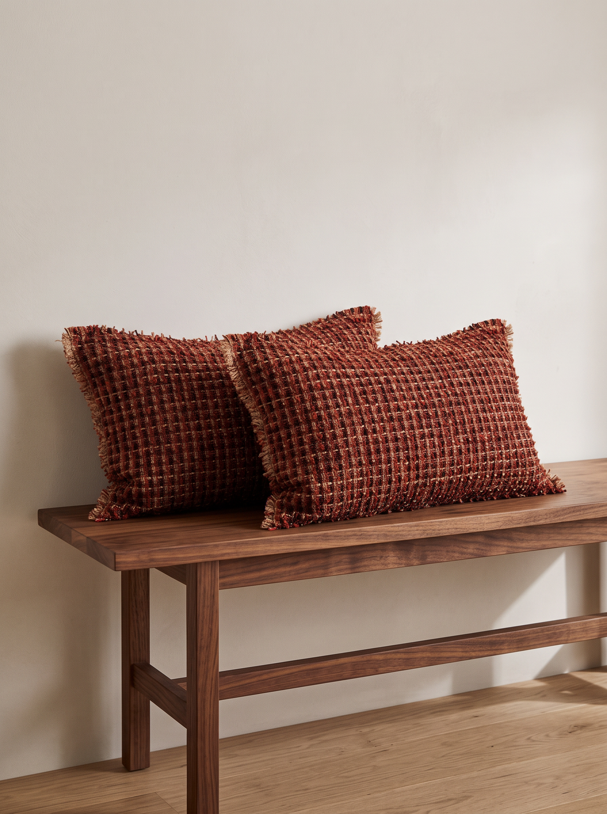 Red & Blue Embroidery Cushion Covers in Brick Red Fringed Lumbar, styled at home on a walnut bench