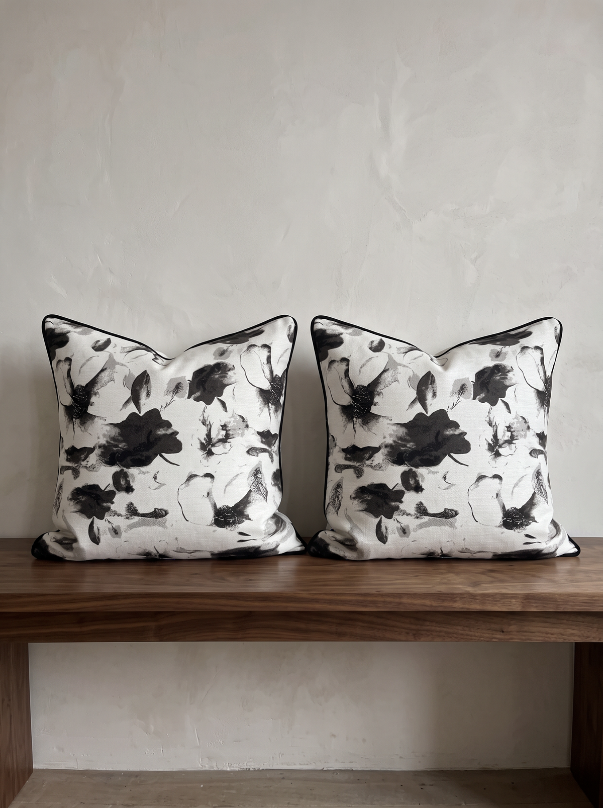Black & White Floral Jacquard Cushion Covers, styled at home on a walnut bench