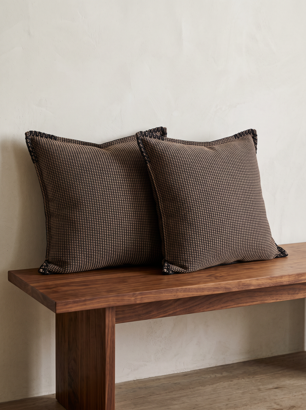 Chocolate Check Jacquard Cushion Covers, styled at home on a walnut bench