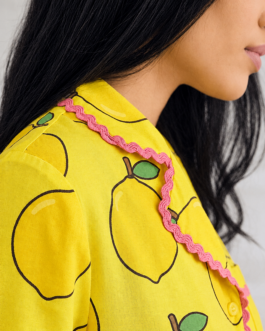 Ripe Lemon cotton set with lemon print and pink trim, worn.