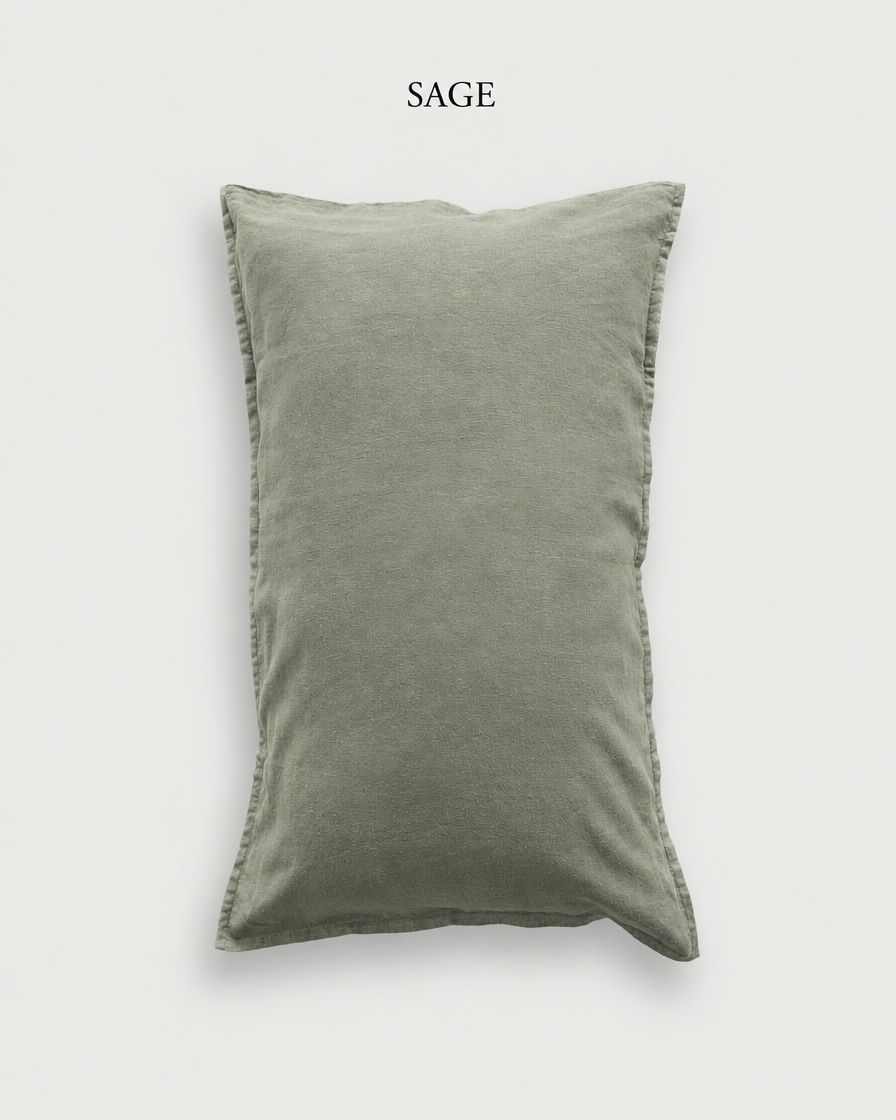 Sage green French linen pillowcase, shown against a pale ground