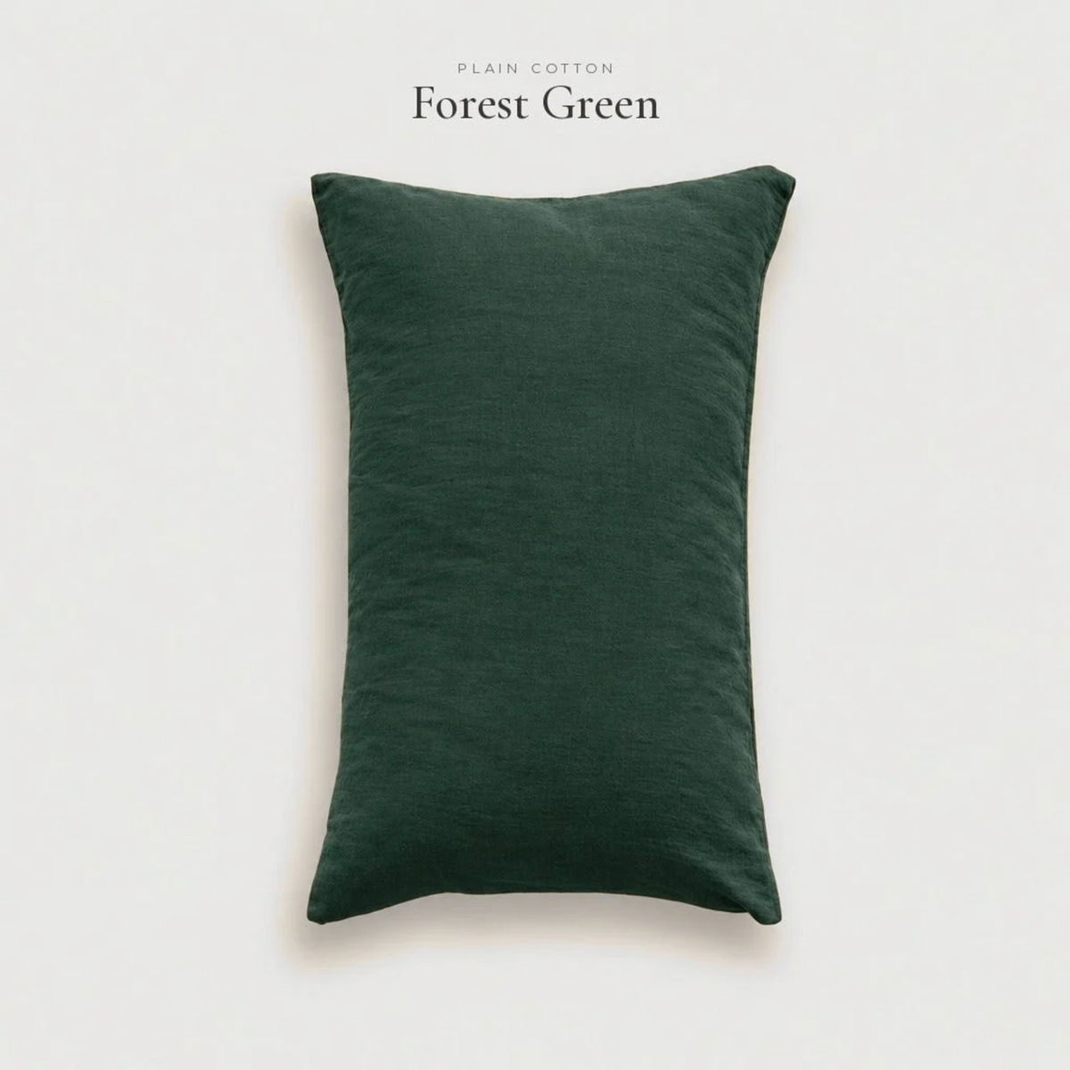 Forest green plain cotton pillowcase in a studio shot on a pale grey background
