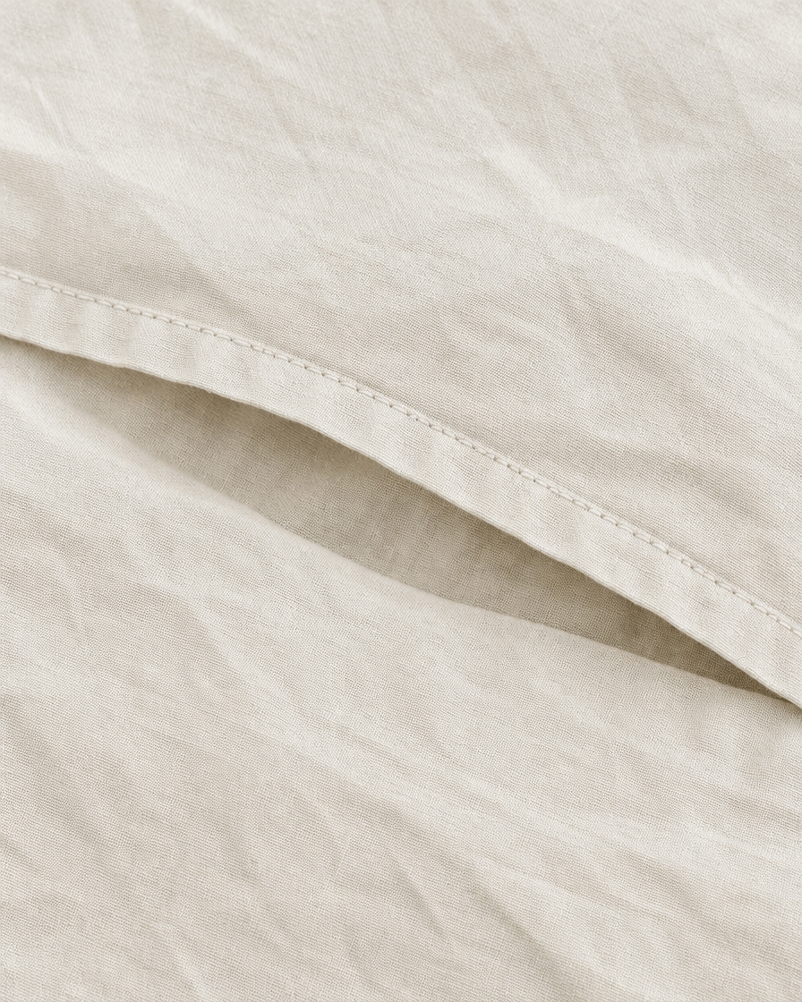 Close-up of stitched envelope opening hem of the pillowcase in Off White Plain Cotton