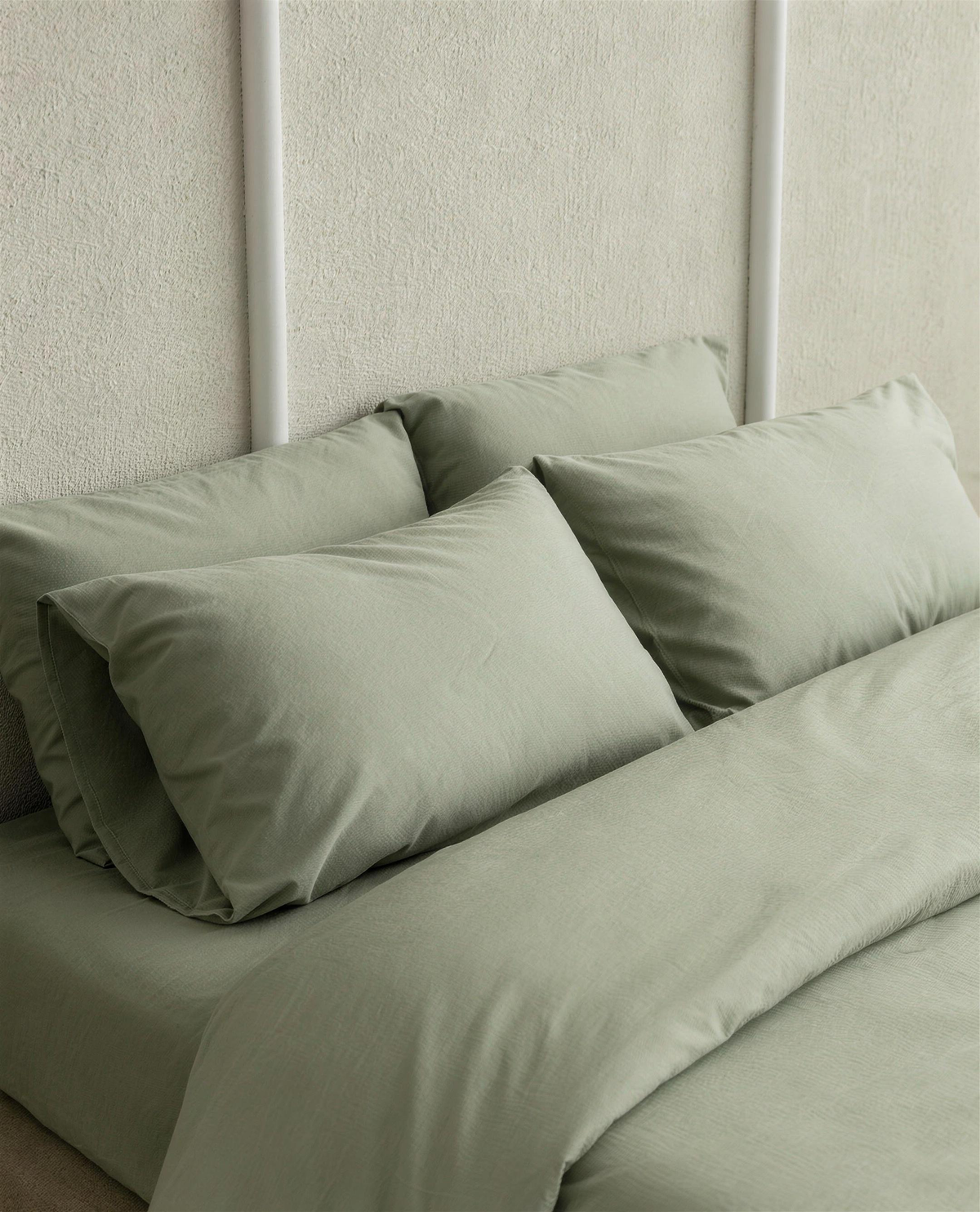 Mint Green silky cotton sateen pillowcases on a bed