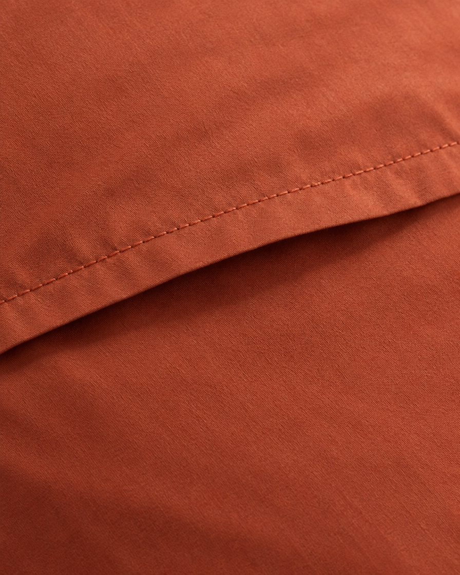 Close-up of stitched envelope opening hem of the pillowcase in Rust Silky Cotton