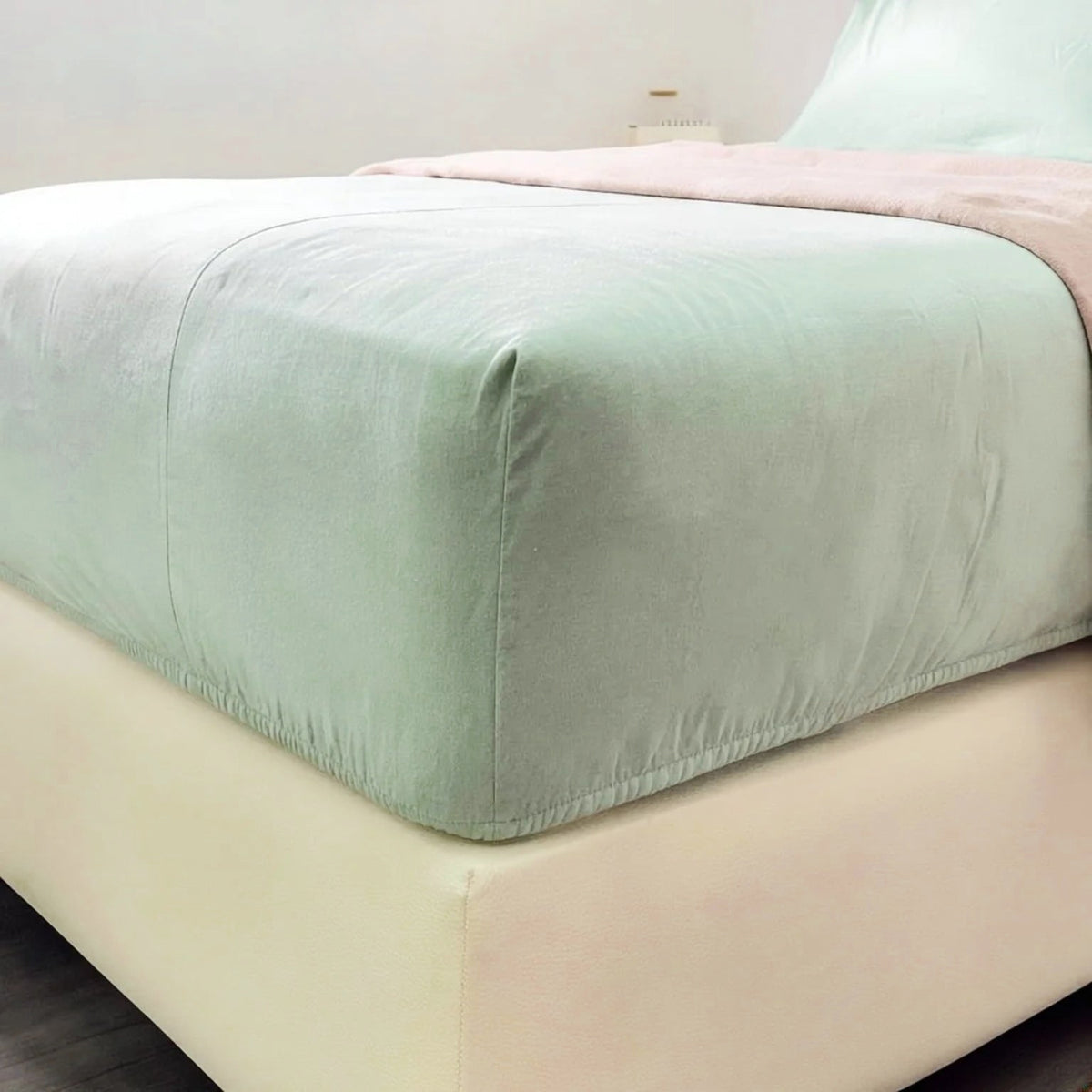 Mint Green plain cotton fitted sheet stretched over a mattress corner.