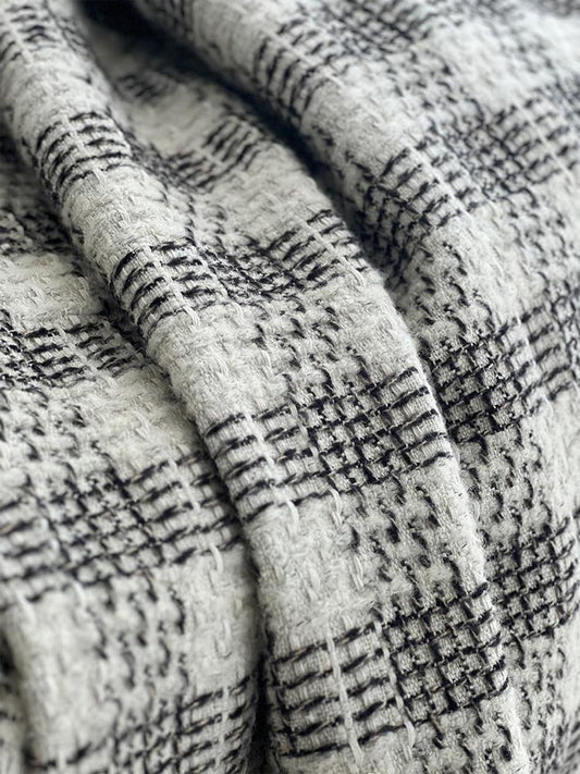 Close-up of a black and white check wool blend throw with a brushed mohair surface