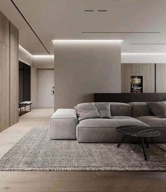 Heathered wool loop-pile rug under a grey corner sofa in a living room