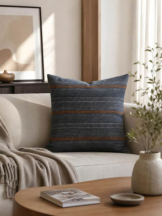 Navy and rust striped jacquard cushions in hemp cotton grouped on a sofa