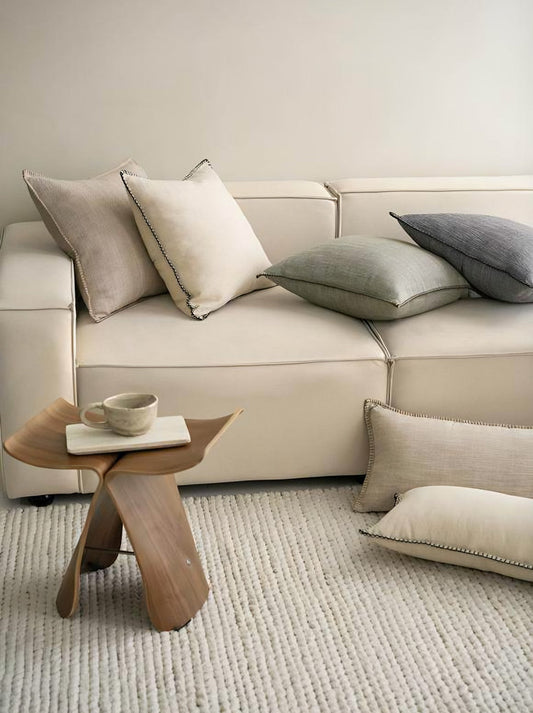 Cocoa milk cushion cover with a fine woven herringbone pattern and twisted cord edge