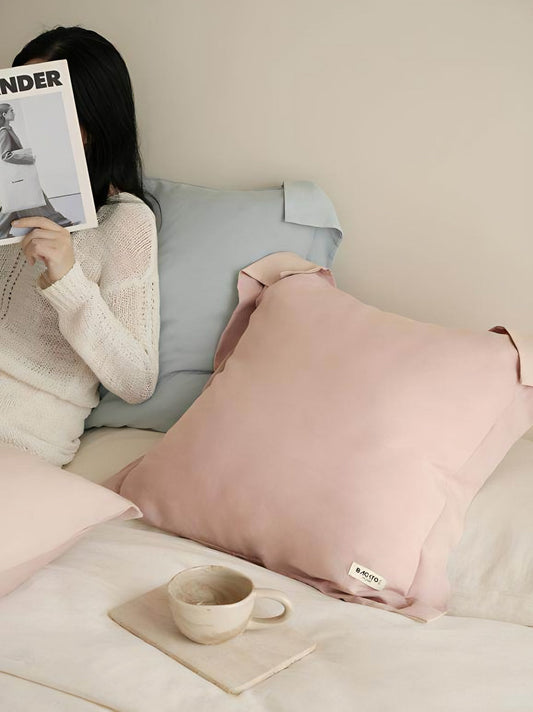 Powder blue two-tone cushion covers in lyocell linen with a soft sheen on a sofa