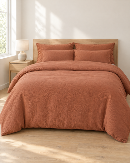 Copper Cloud Cotton bedding set, crinkled double gauze duvet cover and pillowcases on a made bed