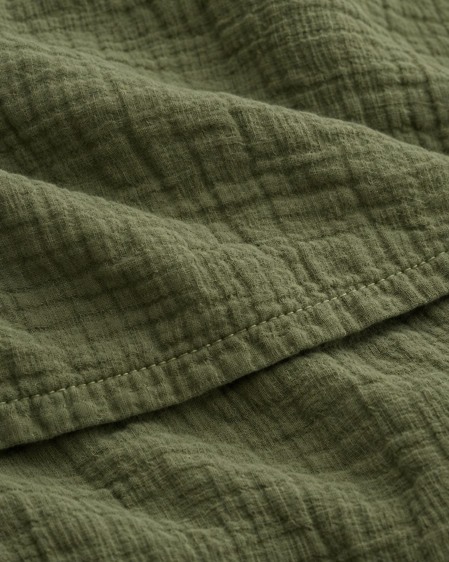 Close-up of stitched hem of the duvet cover in Juniper Green Cloud Cotton