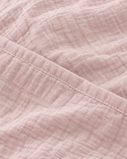 Close-up of the stitched hem on the Pale Pink cloud cotton duvet cover in soft dusty rose
