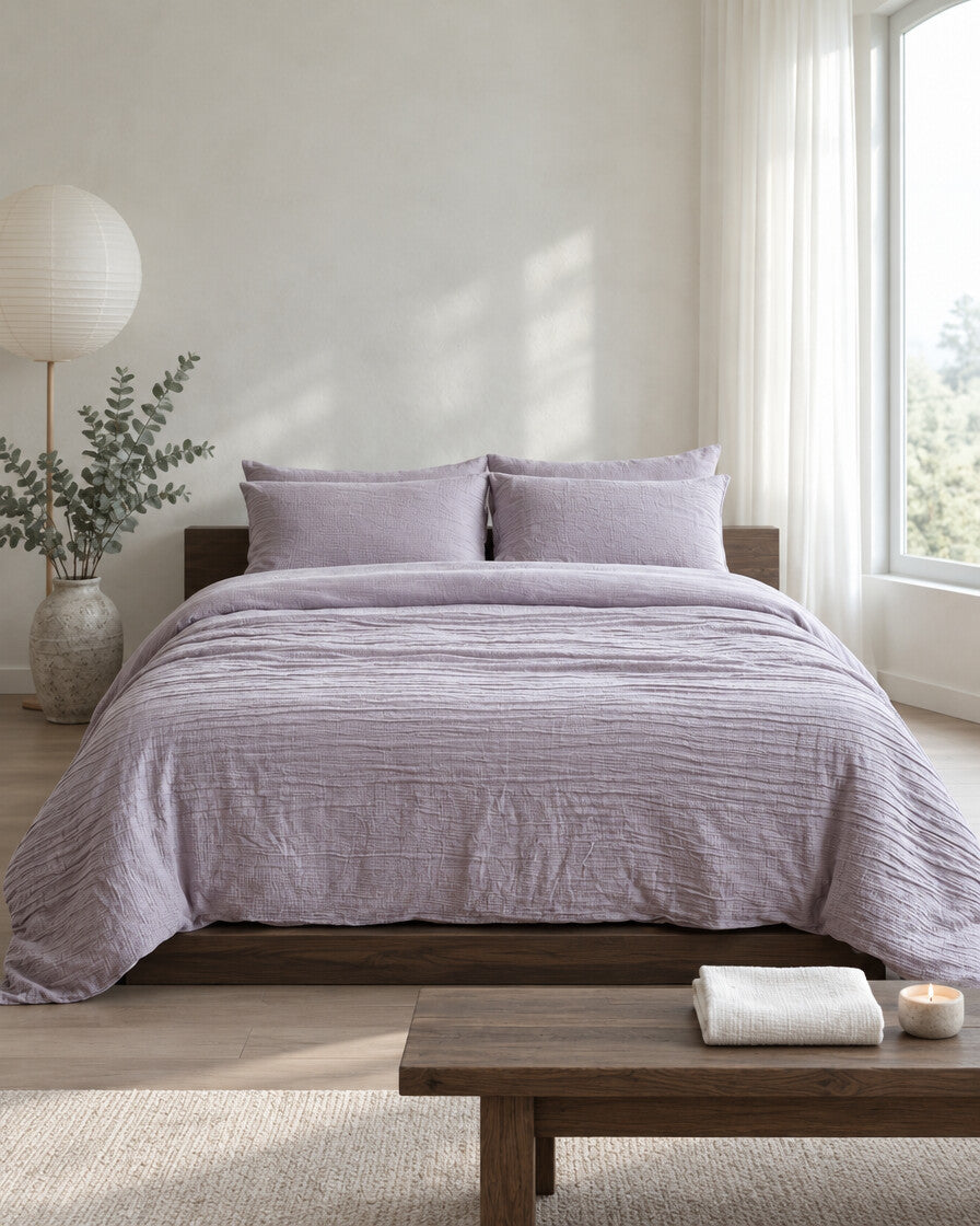 Lilac cloud cotton bedding set in a calm Japandi bedroom on a low dark-oak bed