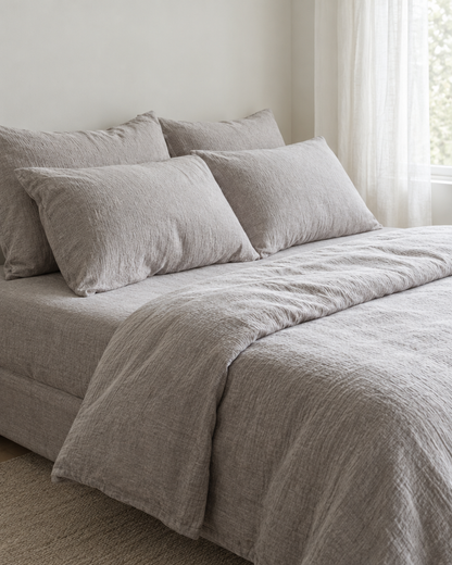 Warm Grey Bedding Set - Cloud Cotton made up on a bed in a calm, light bedroom