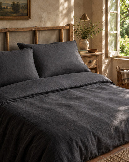 Charcoal French linen pillows and sheet, styled in a relaxed European country-house bedroom