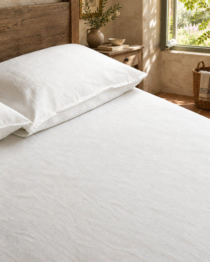 White French linen sheet and pillowcase, styled in a relaxed European country-house bedroom