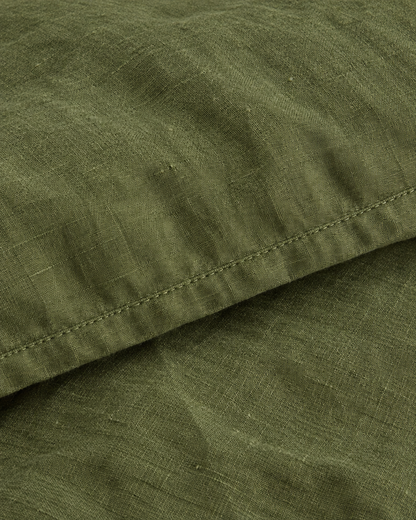 Close-up of stitched hem of the duvet cover in Moss Green Linen