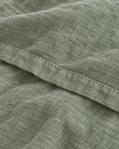 Close-up of stitched hem of the duvet cover in Sage Linen