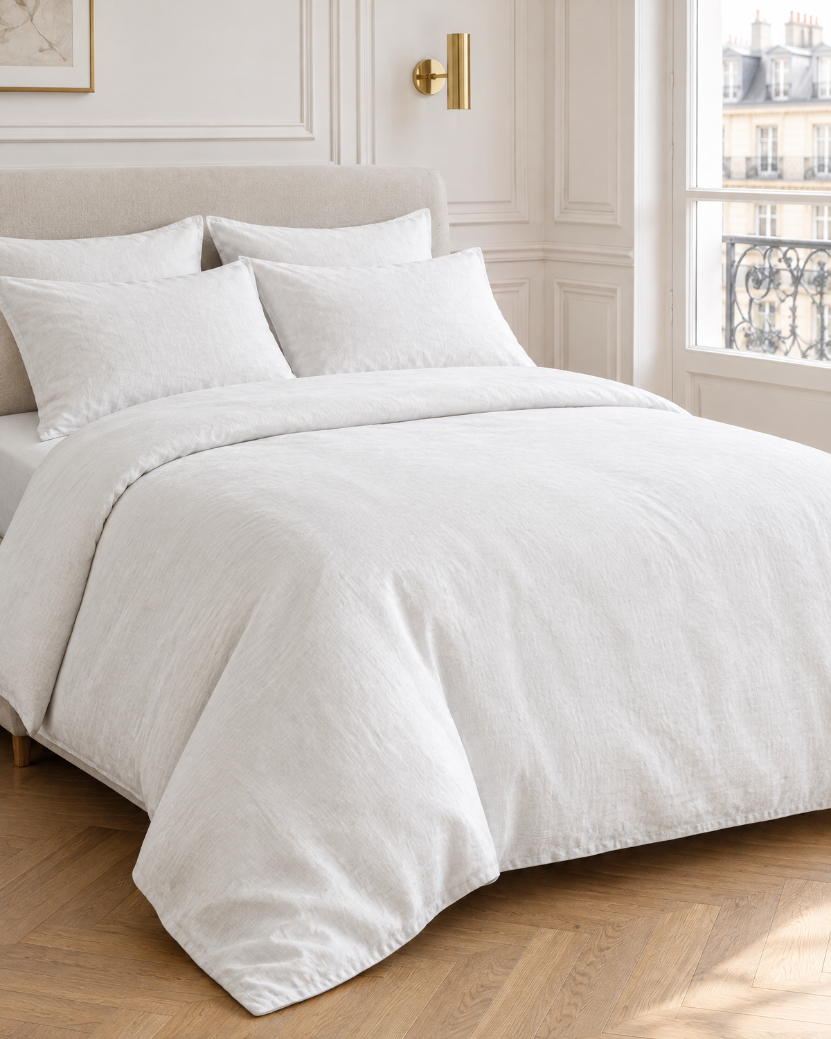 Snow linen bedding set on a made bed in a bright bedroom