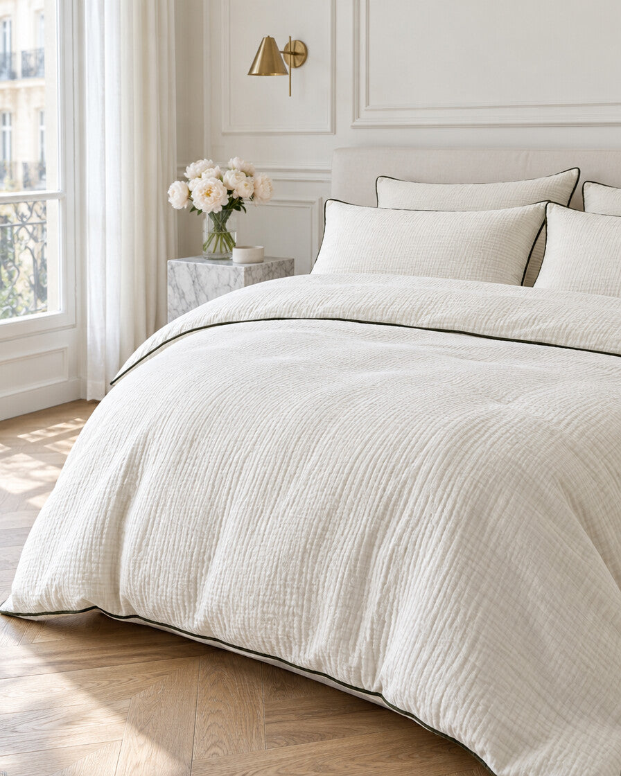 Cream piped cloud cotton bedding set in a Parisian bedroom with panelled walls and fresh peonies
