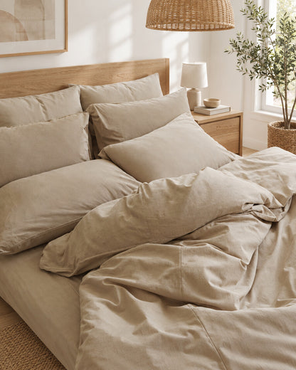 Sand plain cotton bedding, styled in a bright modern townhouse bedroom