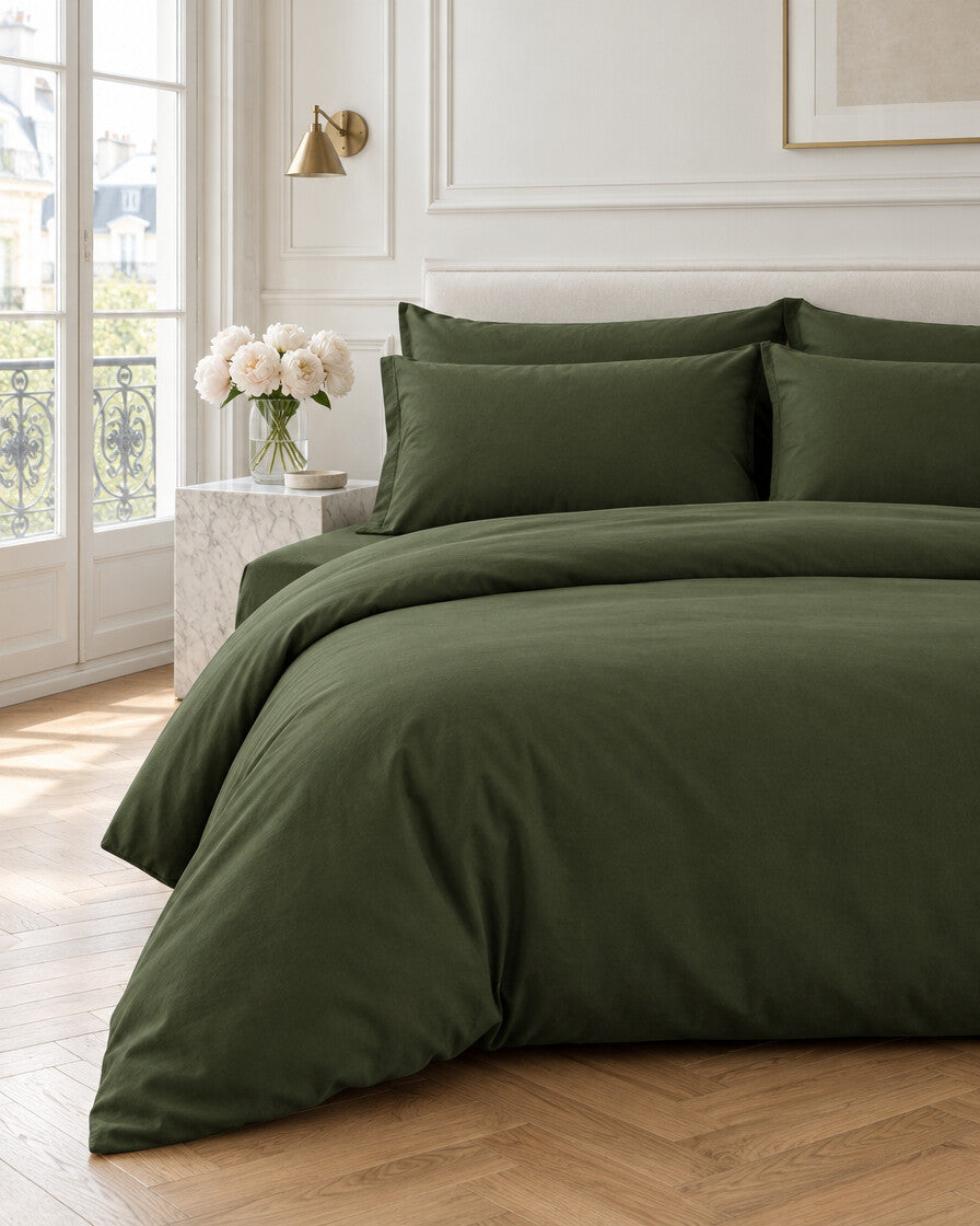 Forest green plain cotton bedding set in a Parisian bedroom with panelled walls and fresh peonies