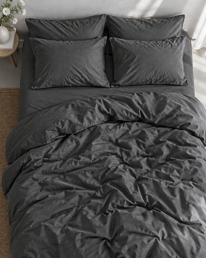 Charcoal Grey silky cotton bedding from above, the duvet softly rumpled over the matching fitted sheet and pillows