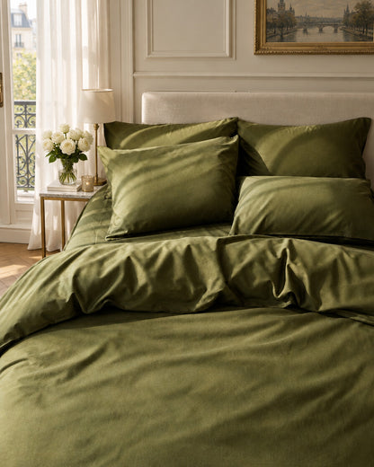Olive green silky cotton bedding, styled in an elegant Parisian apartment bedroom