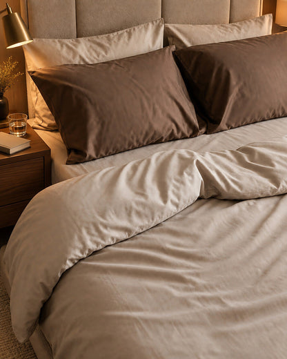 Taupe and brown silky cotton bedding, styled in a boutique-hotel suite