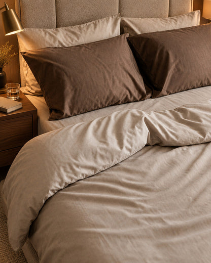 Taupe and brown silky cotton bedding, styled in a boutique-hotel suite