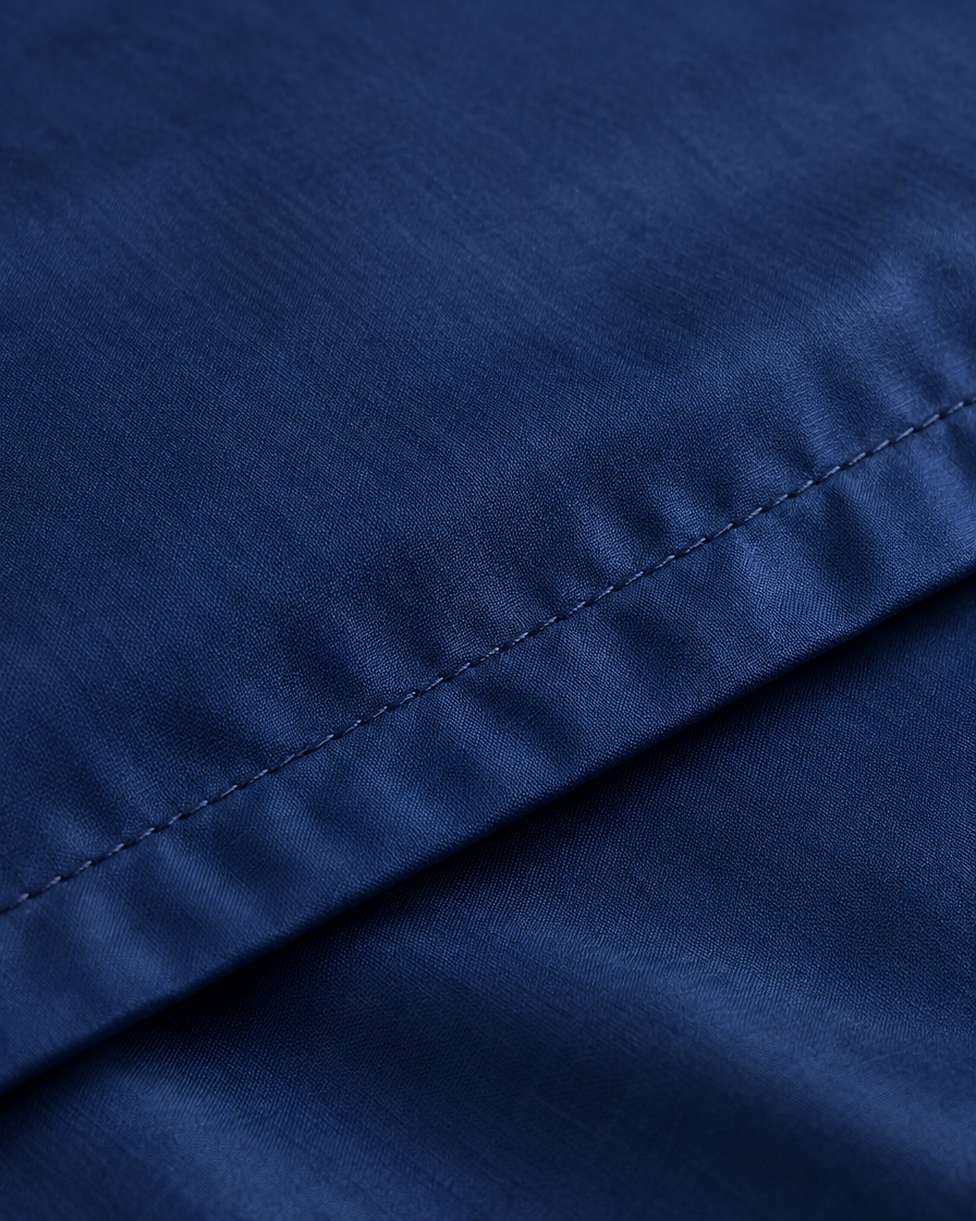 Close-up of stitched hem of the duvet cover in Marine Blue Silky Cotton