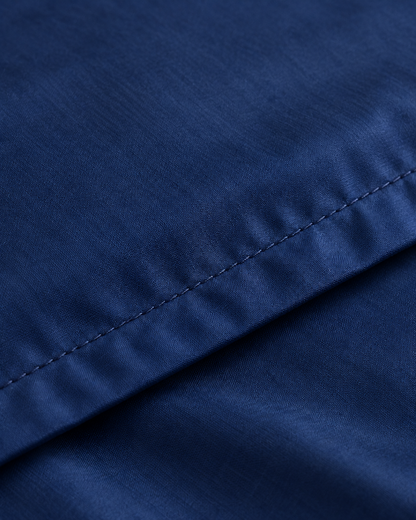 Close-up of stitched hem of the duvet cover in Marine Blue Silky Cotton