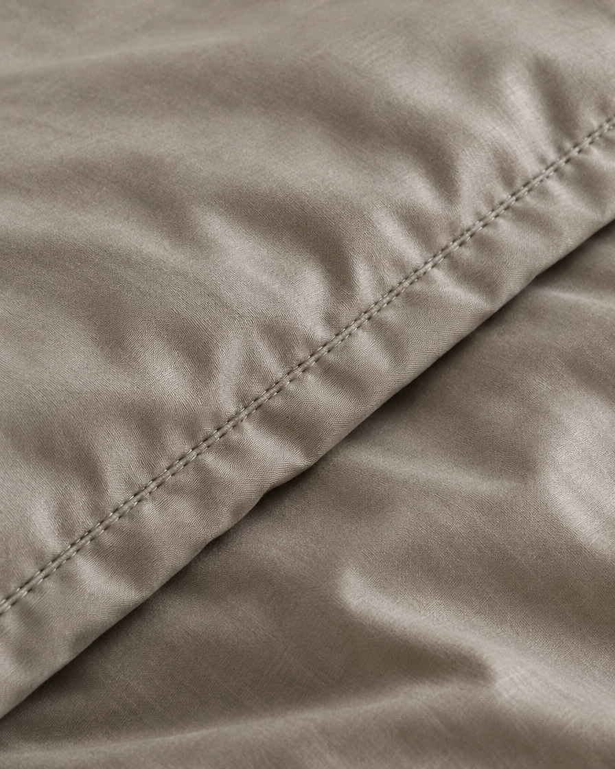 Close-up of stitched hem of the duvet cover in Dove Grey Silky Cotton