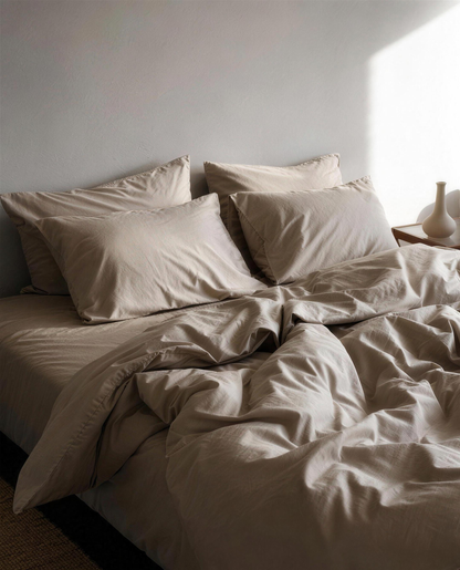 Dove Grey silky cotton sateen bedding set on a bed