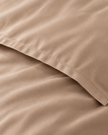 Macro of the stitched envelope end of a Light Beige silky cotton body pillowcase in beige sateen.
