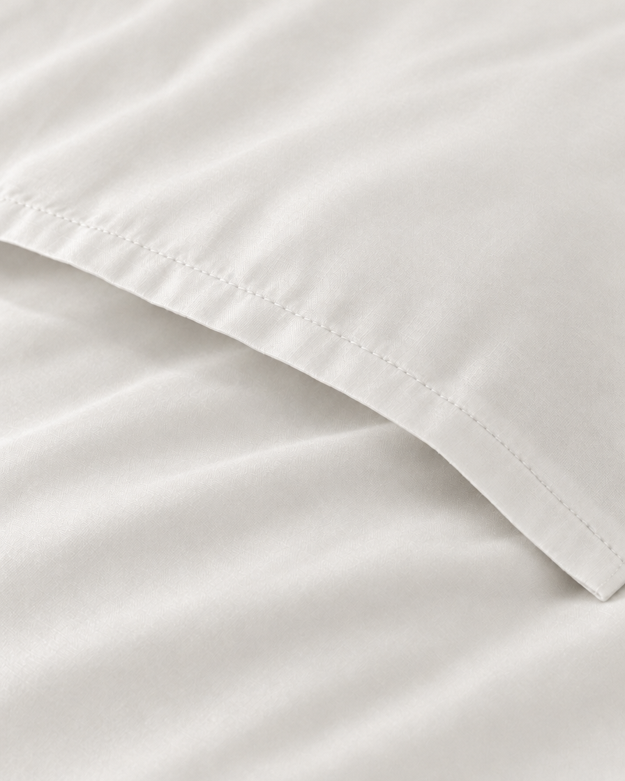 Macro of the stitched envelope end of a Milky White silky cotton body pillowcase in white sateen.