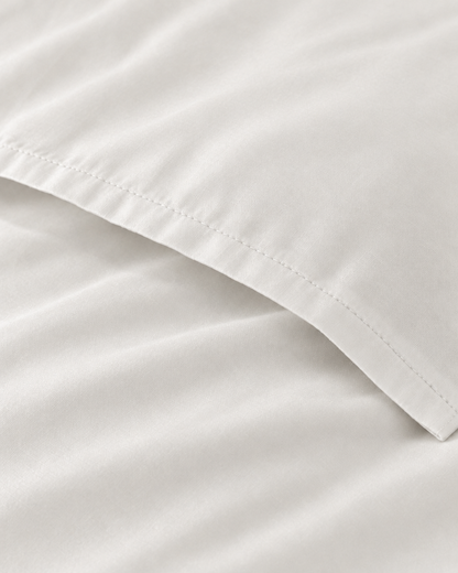 Macro of the stitched envelope end of a Milky White silky cotton body pillowcase in white sateen.