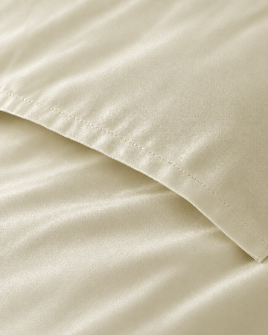 Macro of the stitched envelope end of a Vanilla silky cotton body pillowcase in cream sateen.
