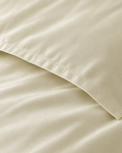 Macro of the stitched envelope end of a Vanilla silky cotton body pillowcase in cream sateen.
