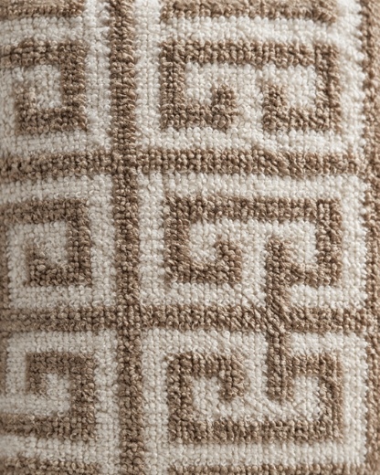 Macro close-up of the caramel key-fret lattice worked in loop pile on an ivory loop-pile ground
