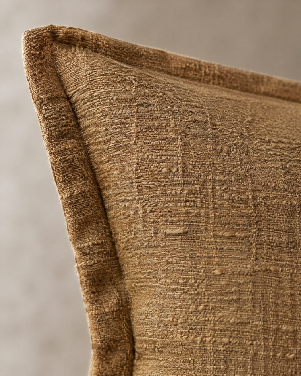 Macro close-up of the caramel slub jacquard, thick-thin slubs in a mottled caramel weave with the flange