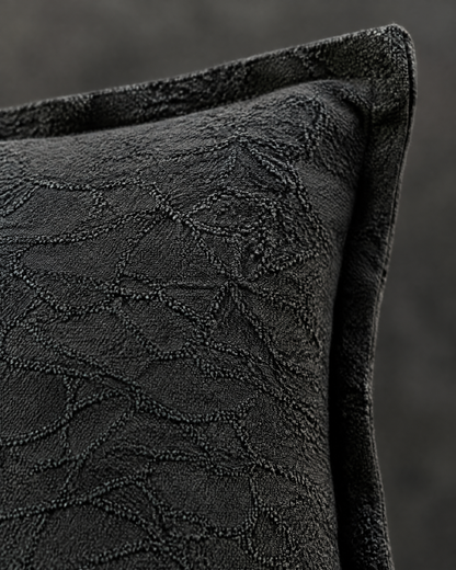Macro close-up of the charcoal jacquard, a tone-on-tone crackle pattern in cotton linen with the flat flange