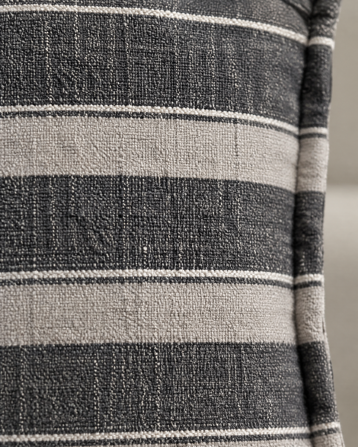 Macro close-up of the charcoal wide stripe, charcoal and stone linen bands edged with fine ivory pinlines